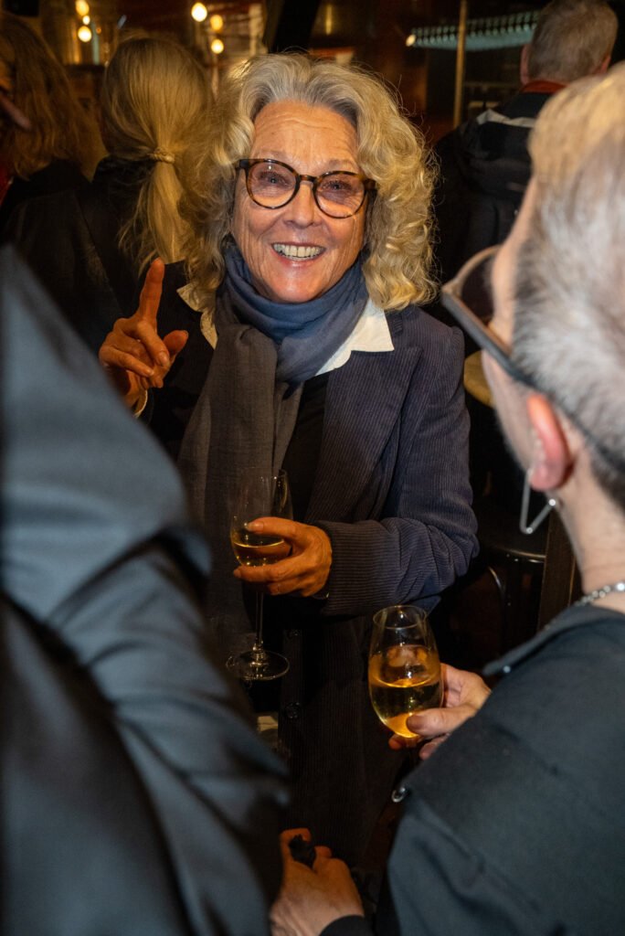 Guests talking over drinks at a premiere reception in Stockholm – event photography