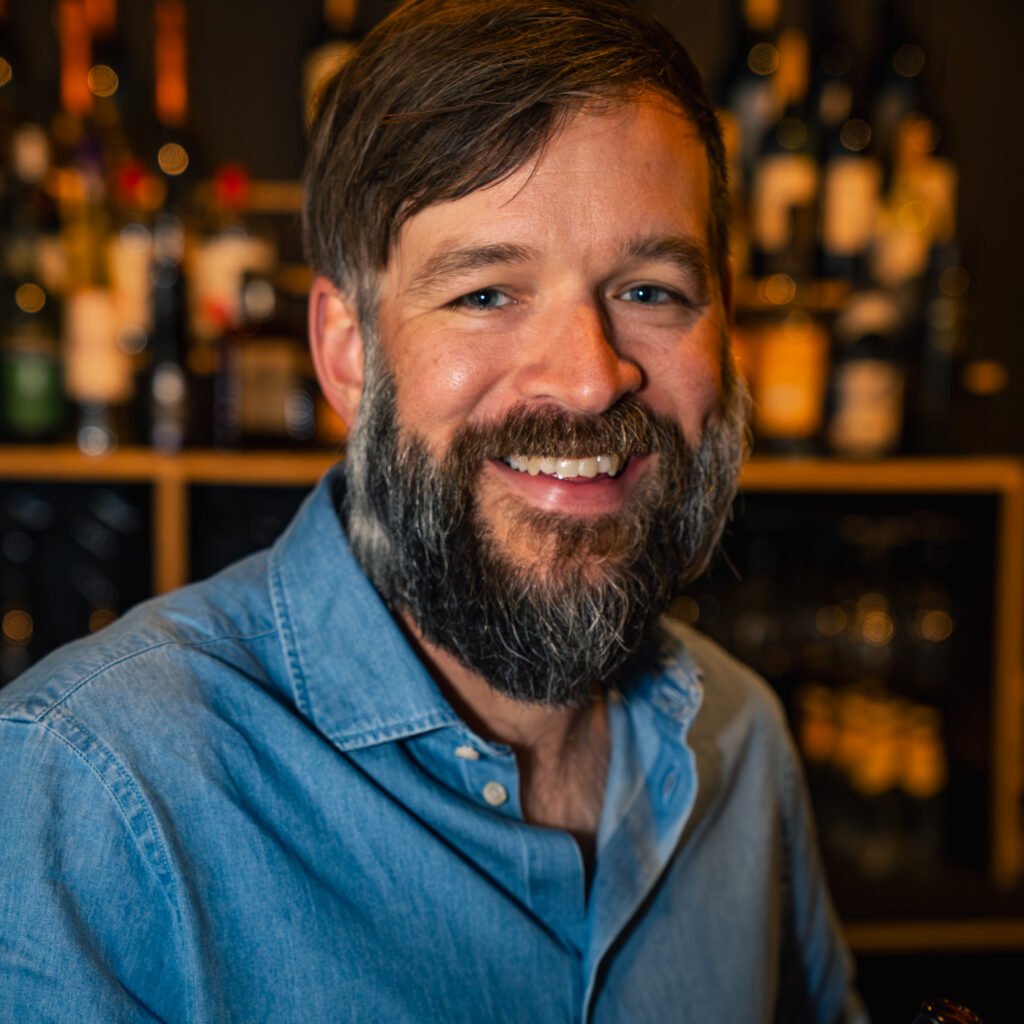 Smiling portrait in front of a bar, Stockholm portrait photographer